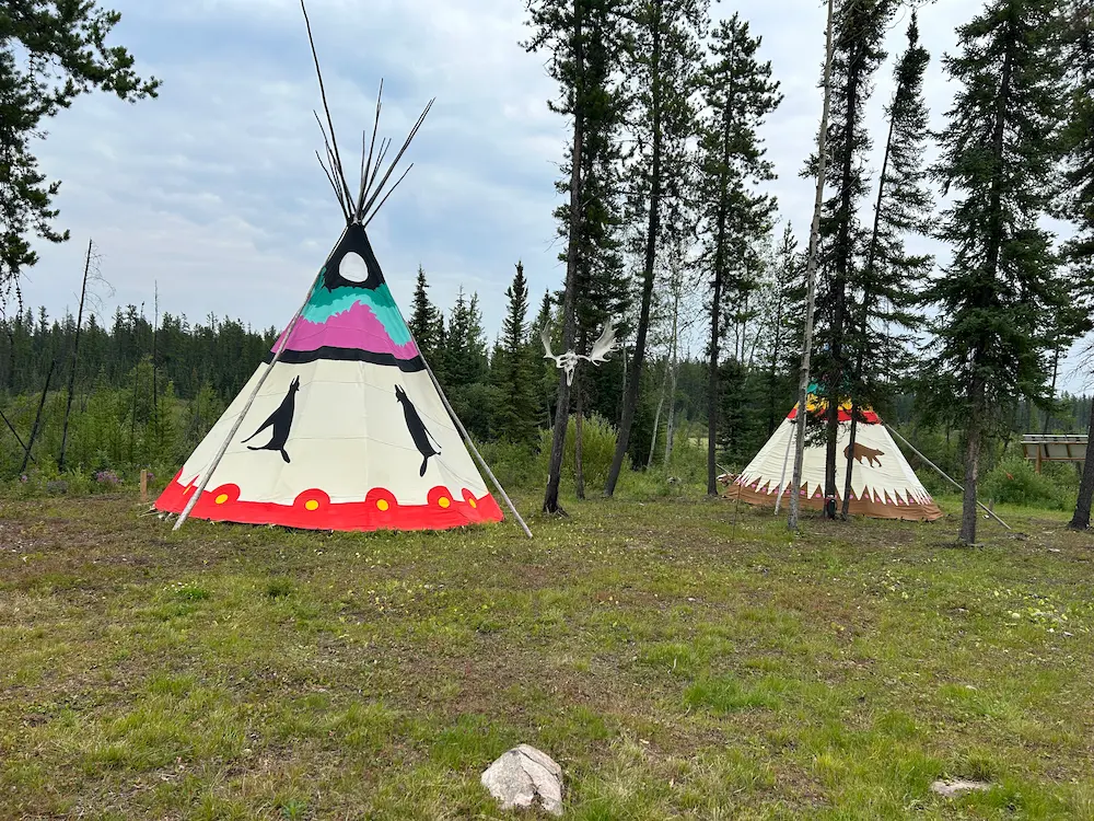 Tipi at Aurora Borealis Indigenous Village in Fort McMurray, Alberta surrounded by northern forest and cultural significance